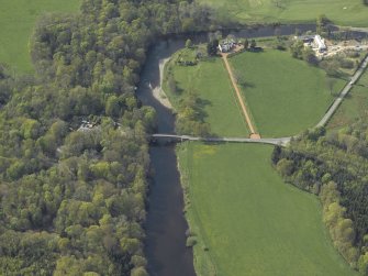 Oblique aerial view centred on the road bridge with the house adjacent, taken from the ESE.