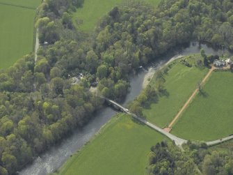 Oblique aerial view centred on the road bridge with the house adjacent, taken from the E.