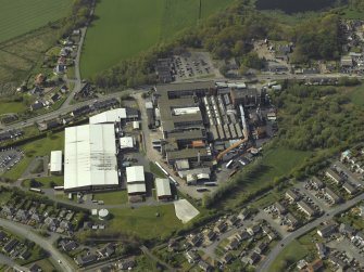 Oblique aerial view centred on the factory, taken from the SE.