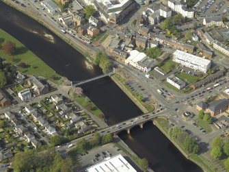 Oblique aerial view centred on the road bridge and suspension bridge, taken from the S.