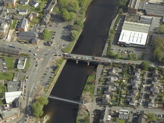 Oblique aerial view centred on the road bridge and suspension bridge, taken from the NNW.