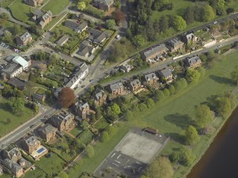 Oblique aerial view centred on the houses, taken from the NW.