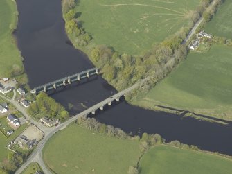 Oblique aerial view centred on the road bridge and barrage, taken from the SW.