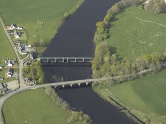 Oblique aerial view centred on the road bridge and barrage, taken from the S.