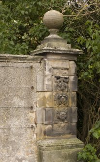 Detail of gate pier to NE of main house showing carved stonework and ball finial from S.