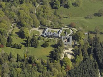 Oblique aerial view centred on Craigengillan House and Stables, taken from the SW.