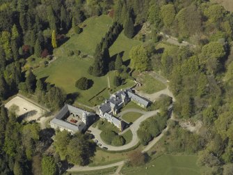 Oblique aerial view centred on Craigengillan House and Stables, taken from the ESE.