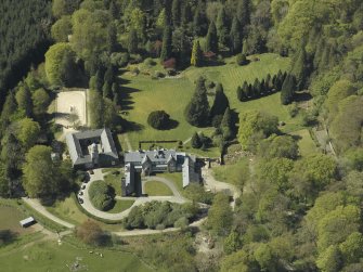 Oblique aerial view centred on Craigengillan House and Stables, taken from the NE.