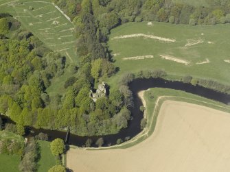 Oblique aerial view centred on the remains of the old castle, taken from the SE.