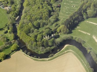 Oblique aerial view centred on the remains of the old castle, taken from the NE.