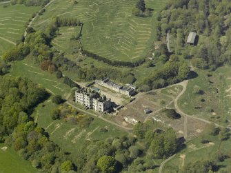 Oblique aerial view centred on the ruins of the country house, taken from the E.