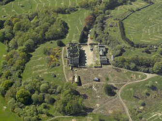 Oblique aerial view centred on the ruins of the country house, taken from the NE.
