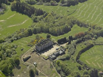 Oblique aerial view centred on the ruins of the country house, taken from the NNW.