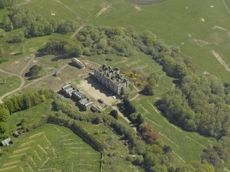 Oblique aerial view centred on the ruins of the country house, taken from the W.