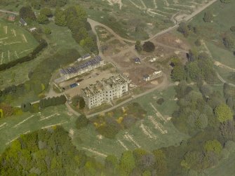 Oblique aerial view centred on the ruins of the country house, taken from the SSE.