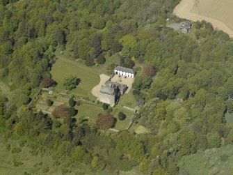 Oblique aerial view centred on the castle and country house, taken from the SE.