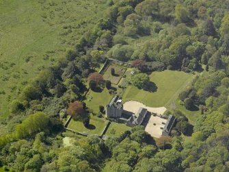 Oblique aerial view centred on the castle and country house, taken from the NE.