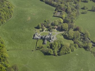 General oblique aerial view of the castle and country house, taken from the SW.
