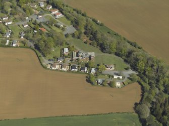 General oblique aerial view centred on the house, with caravan site adjacent, taken from the WSW.