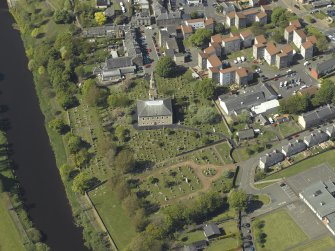 Oblique aerial view centred on the Church with the churchyard adjacent, taken from the SE.