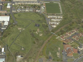 Oblique aerial view centred on the remains of Ardrossan Castle with the Monument and Church adjacent, taken from the SW.