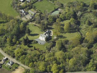 Oblique aerial view centred on the house with the walled garden adjacent, taken from the SE.