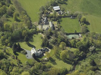 Oblique aerial view centred on the house with the walled garden adjacent, taken from the ESE.