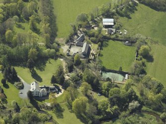 Oblique aerial view centred on the house with the walled garden adjacent, taken from the ENE.