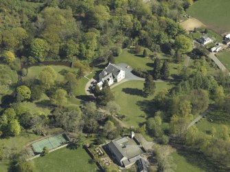 Oblique aerial view centred on the house with the walled garden adjacent, taken from the NW.