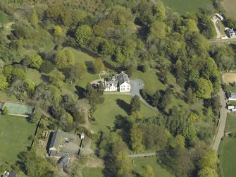 Oblique aerial view centred on the house with the walled garden adjacent, taken from the W.