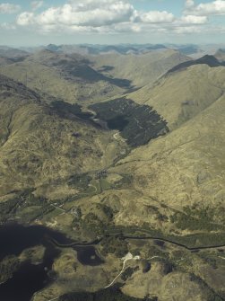 Oblique aerial view looking towards Glen Finnan centred on the Glenfinnan railway viaduct with the Glenfinnan Monument adjacent, view from SSW.