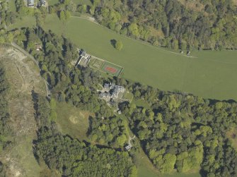 Oblique aerial view centred on the house with the gardener's cottage and walled garden adjacent, taken from the SW.