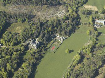 Oblique aerial view centred on the house with the gardener's cottage and walled garden adjacent, taken from the WNW.