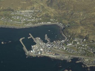 Oblique aerial view centred on the town and station with the harbour adjacent, taken from the WNW.