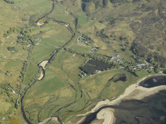 Oblique aerial view centred on the remains of the Barracks and the adjacent modern village, taken from the NW.
