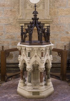 Interior. View of Caen stone font with marble enrichment with oak cover from Christ Church, Lancaster Gate, london demolished 1977