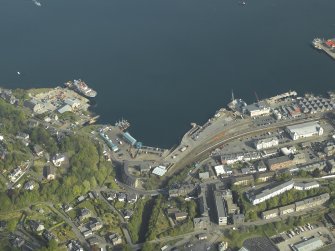 General oblique aerial view of the town centred on the railway station, taken from the S.