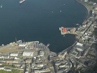 General oblique aerial view of the town centred on the railway station and the pier, taken from the SE.