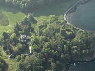 Oblique aerial view of the country house and the remains of the castle, taken from the NNW.