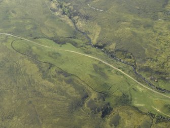 Oblique aerial view centred on the remains of the field banks and rig, taken from the NNE.