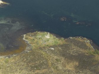 Oblique aerial view centred on the remains of the towerhouse, taken from the S.