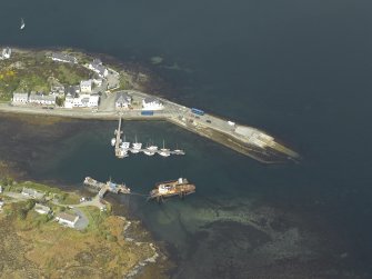 Oblique aerial view centred on the harbour and slipway, taken from the SE.