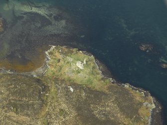 Oblique aerial view centred on the remains of the towerhouse, taken from the SSE.