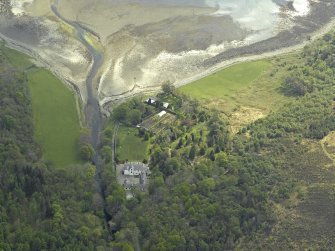 Oblique aerial view centred on the hunting lodge with the church and burial ground adjacent, taken from the NW.