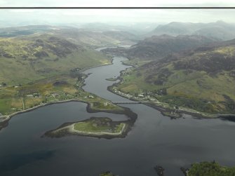 General oblique aerial view looking along Loch Long centred on the road bridge with the castle and village adjacent, taken from the SW.