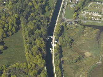 Oblique aerial view centred on the swing bridge and cottage, taken from the SSW.