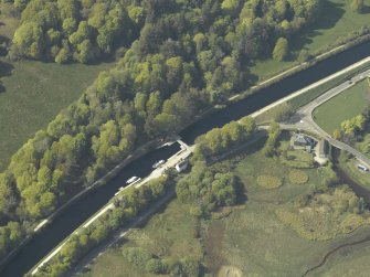 Oblique aerial view centred on the swing bridge and cottage, taken from the SE.