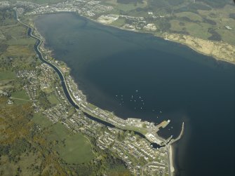 Oblique aerial view looking up the loch across the village and the canal towards the town, taken from the SSW.