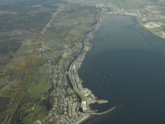 General oblique aerial view looking up the loch across the village and the canal towards the town, taken from the S.