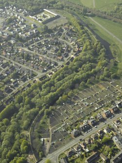 Oblique aerial view of the canal and housing with the farmsteading adjacent, taken from the SE.